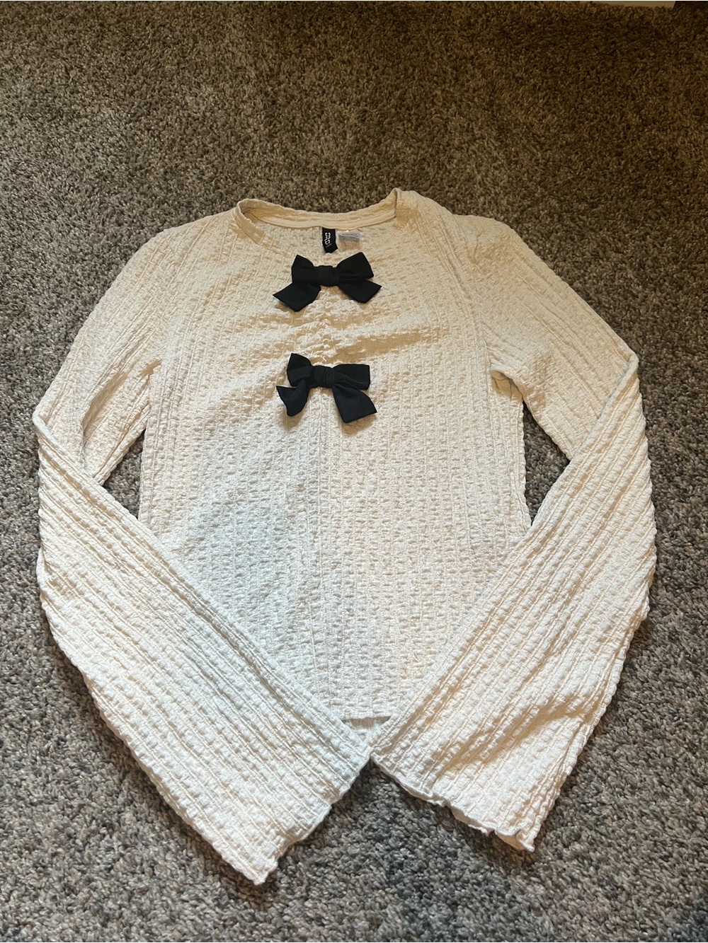 Cream Textured Long-Sleeve Sweater with Black Bow Accents and bell sleeves